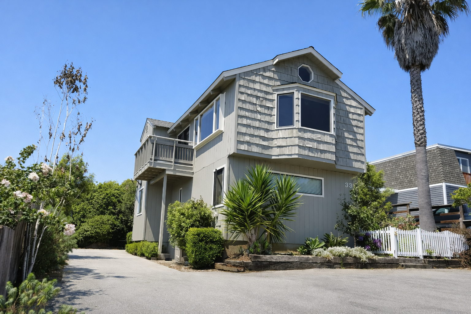 Gray home with palm trees